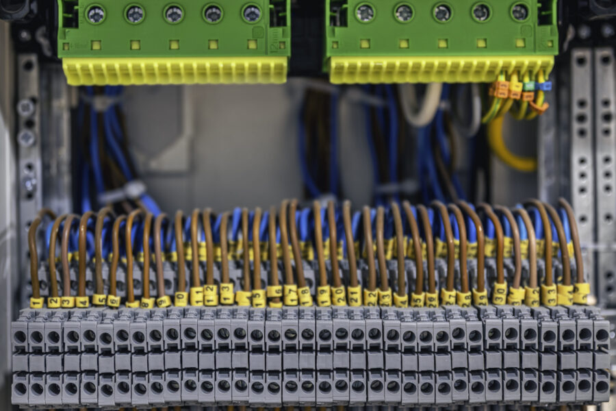 Voltage distributor with automatic switches. Electrical background.