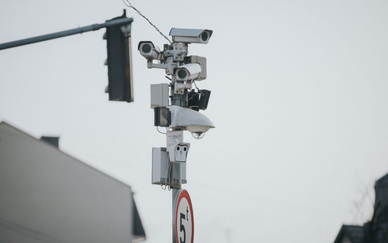 A shallow focus shot of multi-angle traffic cameras on the street pole